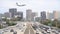 Aerial view of the highway, United Airline airplane landing and downtown