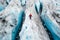 aerial view of a hiker explorer person walking on a glacier, open shot panoramic drone artic exploration, climber exploring cold