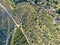 Aerial view of hiking sandy trails in dry green mountain