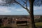 Aerial view from a hill. a quiet, green, quiet and peaceful public park. a solitary bench, a tree and a view of the town