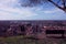 Aerial view from a hill. a quiet, green, quiet and peaceful public park. a solitary bench, a tree and a view of the town