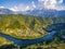 Aerial view of hills and houses next to Neretva river in Bosnia and Herzegovina.