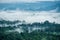 Aerial view of hills in rural covered with fog in the morning