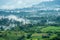 Aerial view of hills in rural covered with fog in the morning