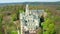 Aerial view of historic chateau Hluboka castle in Hluboka nad Vltavou with lake on the background.