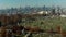 Aerial view of historic tombstones on Calvary Cemetery. Tilt up reveal of skyline with Manhattan skyscrapers. Queens