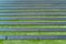 Aerial view of horizontal solar panel in the field with green grass. Green, eco friendly, renewable energy source for