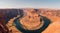 Aerial view of the Horseshoe Bend is a famous meander on the river with a blue sky background