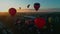 Aerial view of a hot air balloon festival early morning take off into the sun