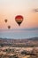 Aerial view of hot ballons flying in sky over Capadoccia during sunsety