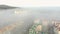 Aerial view at the houses that are covered with morning fog. Flight over the city of Lviv in Ukraine. Fabulous morning