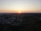 Aerial view of housing estate with sun setting in background