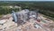 Aerial view of huge modern grain elevator. Food storage, building in progress. Silo farm. Agribusiness development