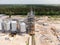 Aerial view of huge modern grain elevator. Food storage, building in progress. Silo farm. Agribusiness development