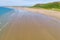 Aerial view of a hugem wide sandy beach at low tide Rhossili, Wales