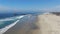 Aerial view of Huntington Pier, beach and coastline during sunny summer day