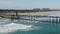 Aerial view of Huntington Pier, beach and coastline during sunny summer day