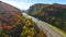 Aerial view of I-40 freeway in North Carolina heading to Asheville through Appalachian mountains in golden fall with