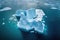 aerial view of iceberg calving in polar ocean