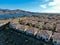 Aerial view of identical residential subdivision condo with big lake and mountain on the background during sunny day