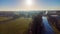 Aerial view of an Idillic river stream canal with grass banks and wild flowers and trees in a scenic landscape on a