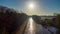 Aerial view of an Idillic river stream canal with grass banks and wild flowers and trees in a scenic landscape on a