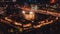 Aerial view of illuminated London tower, orange yellow street lights starting glowing to streets