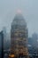 Aerial View of an Illuminated Triangle Shaped Tower Top in Manhattan, New York City. Building Fading Away in the Fog