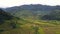 Aerial view of an impressive mountains and hills with rice terraces and village.