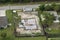 Aerial view of incompleted frame of private home under construction with brick concrete walls ready for installation of