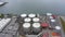 Aerial view of an industrial tanks for fuel in a seaport, shooting from a drone