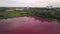 Aerial view of industrial zone with artificial pink reservoir, toxic water