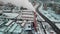 Aerial view of industrial zone with large red and white pipes with white smoke. Smoke is poured from the factory pipe in