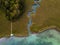 Aerial view on inflow through reeds to Lake `Faaker See` in Carinthia Kaernten, Austria with canoes and a jetty with a