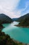 Aerial view Inguri reservoir lake in Upper Svaneti region, Georgia. Summer day, Emerland water. The mountains are covered with