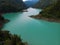 Aerial view Inguri reservoir lake in Upper Svaneti region, Georgia. Summer day, Emerland water. The mountains are covered with