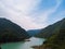 Aerial view Inguri reservoir lake in Upper Svaneti region, Georgia. Summer day, Emerland water. The mountains are covered with