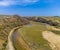 An aerial view inland above the Pennard Pill stream from the Three Cliffs Bay, Gower Peninsula, Swansea, South Wales