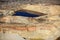 An aerial view inside an open pit copper mine.