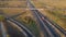 Aerial view. Interchange on the intercity highway. Cars and trucks travel in different directions. Two stripes in each