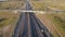 Aerial view. Interchange on the intercity highway. Cars and trucks travel in different directions. Two stripes in each