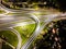 Aerial view interchange ring road and motorway freeway highways and moving headlight cars transportation with over lighting the