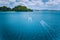 Aerial view of island hopping boats on the way to tour route abound picturesque archipelago. El Nido, Palawan