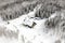 aerial view of an isolated cabin in snowy landscape