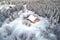 aerial view of an isolated cabin in snowy landscape