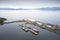 Aerial view of isolated harbour port with ferry ships and grey landscape from above on west coast Scotland near Greenock