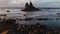 Aerial view of an isolated rock in the ocean. Black Volcanic Sand Beach, Atlantic Ocean. Benijo beach, Tenerife, Canary