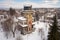 aerial view of italianate structure with tower draped in snow