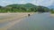 Aerial View Jeep Crosses River and Moves on Gravel Bank