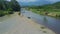 Aerial view jeep drives on gravel river bank against landscape